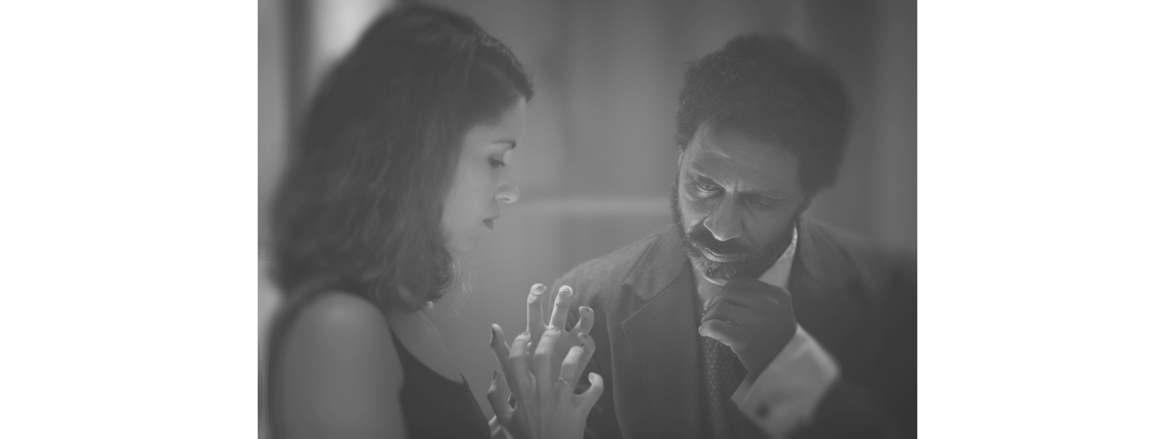 Black and white photo of a women performing modern dance on a dark background.