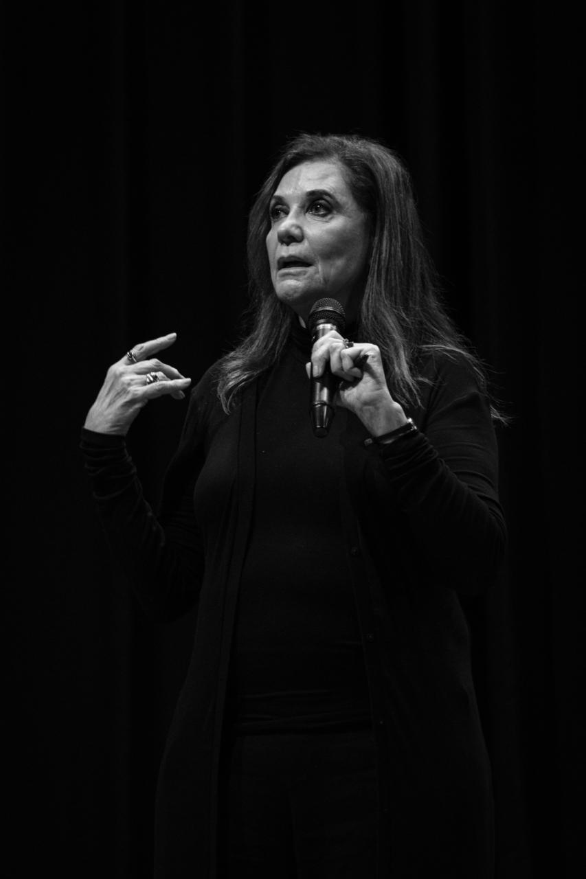 Black and white portrait of a dance instructor against a light background.