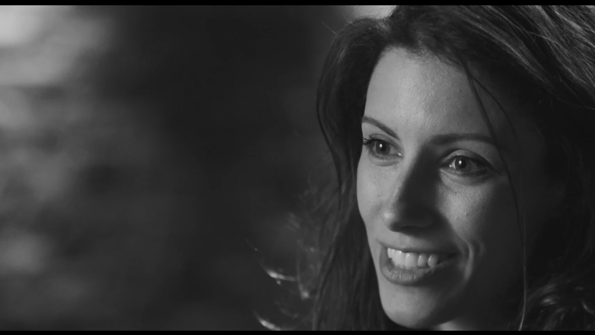Photo of a female dancer in a modern dance pose with a spotlight on her.